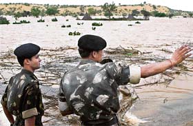 Army officers inspect the flooded hit areas of Malva village in Rajasthan
