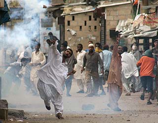 Protesters hurl stones at the police during a protest against the killing of Baluch leader Nawab Akbar Khan Bugti in Karachi on Monday.