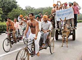 Unemployed Punjab Armed Police personnel protest on rickshaws and rehras in Sector 17, Chandigarh, on Tuesday