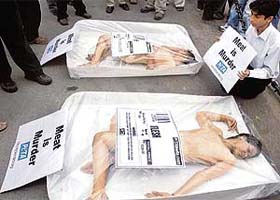 Members of PETA lie as frozen meat during a protest outside the ongoing International Livestock and Dairy Expo 2006 at Pragati Maidan in New Delhi