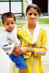 A mentally challenged woman with her child at Mamoon police station at Pathankot. 