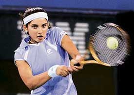 Sania Mirza returns a shot to Karolina Sprem of Croatia during their first round match at the US Open in New York on Monday