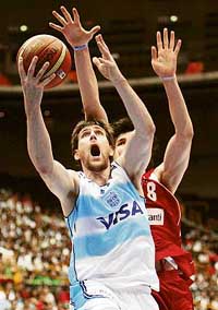 Argentinas Andres Nocioni goes up for a basket past Turkeys Ersan Ilyasova during their quarter-final match at the World Basketball Championship in Saitama on Tuesday