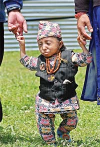 Fourteen-year-old Khagendra Thapamagar from the west Nepali village of Baglung walks in between his parents in Kathmandu in this file photo.