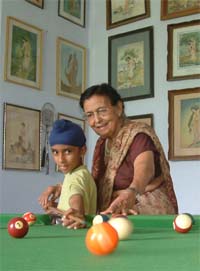 Phulan Rani, when she is not busy painting, plays billiards with her grandson