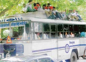 Unmindful of the risk involved, a private bus carries students wholesale on its roof in Mohali