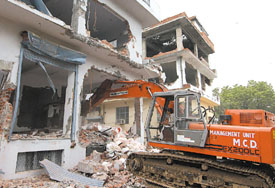 MCD bulldozer demolishing the illegal constructions at Karol Bagh in the Capital on Wednesday
