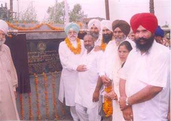 This file photo shows Jalandhar MP Rana Gurjit Singh (first from left in front row) and tainted ZP chairman Harjinder Singh Khalsa (second from left in second row) at a stone laying function for the link road from Lakhan Kalan to Gurdwara Harnarayan Pur on August 27, this year.