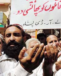 Supporters of slain Baluch leader Nawab Khan Bugti offer prayer in Peshawar