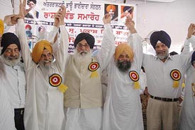 SAD chief Parkash Singh Badal along with Balwinder Singh Saifdipur of the International Bhau Bhaichara Organisation at a rally in Sanaur on Thursday. 