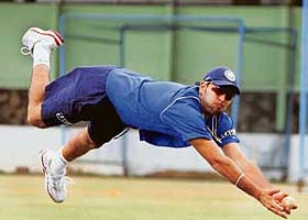 Yuvraj Singh dives to take a catch during a practice session at the National Cricket Academy in Bangalore