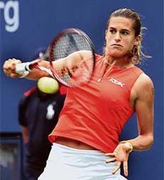 Top seed Amelie Mauresmo of France plays a shot to Kristina Barrois of Germany in the first round of the US Open at Flushing Meadows, New York