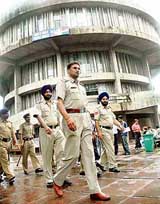 Chandigarh police personnel take a round of Student Centre at Panjab University in Chandigarh on Friday.