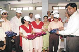 Senior regional manager-cum-state-level coordinator, UT, Hindustan Petroleum Corporation, Vikas Yadav distributes uniforms among students at the Institute for the Blind, Sector 26, Chandigarh, on Friday.