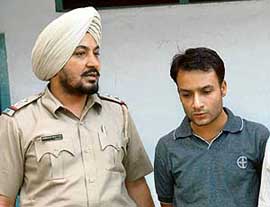 Rohit Verma in police custody at Sector 17 police station in Chandigarh on Friday.