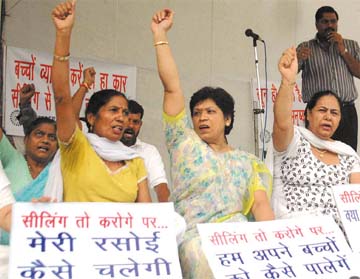 Family members of traders sitting on dharna against the sealing drive in the Capital on Saturday.