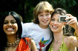 Miss Lebanon Annabella Hilal (right) takes a picture with Polish Maria next to Miss India Natasha Suri (left) at the Lazienki park in Warsaw