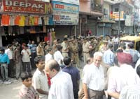 Delhi Police guarding the situation during the MCD sealing drive at Kotla Mubarakpur in the Capital on Monday.