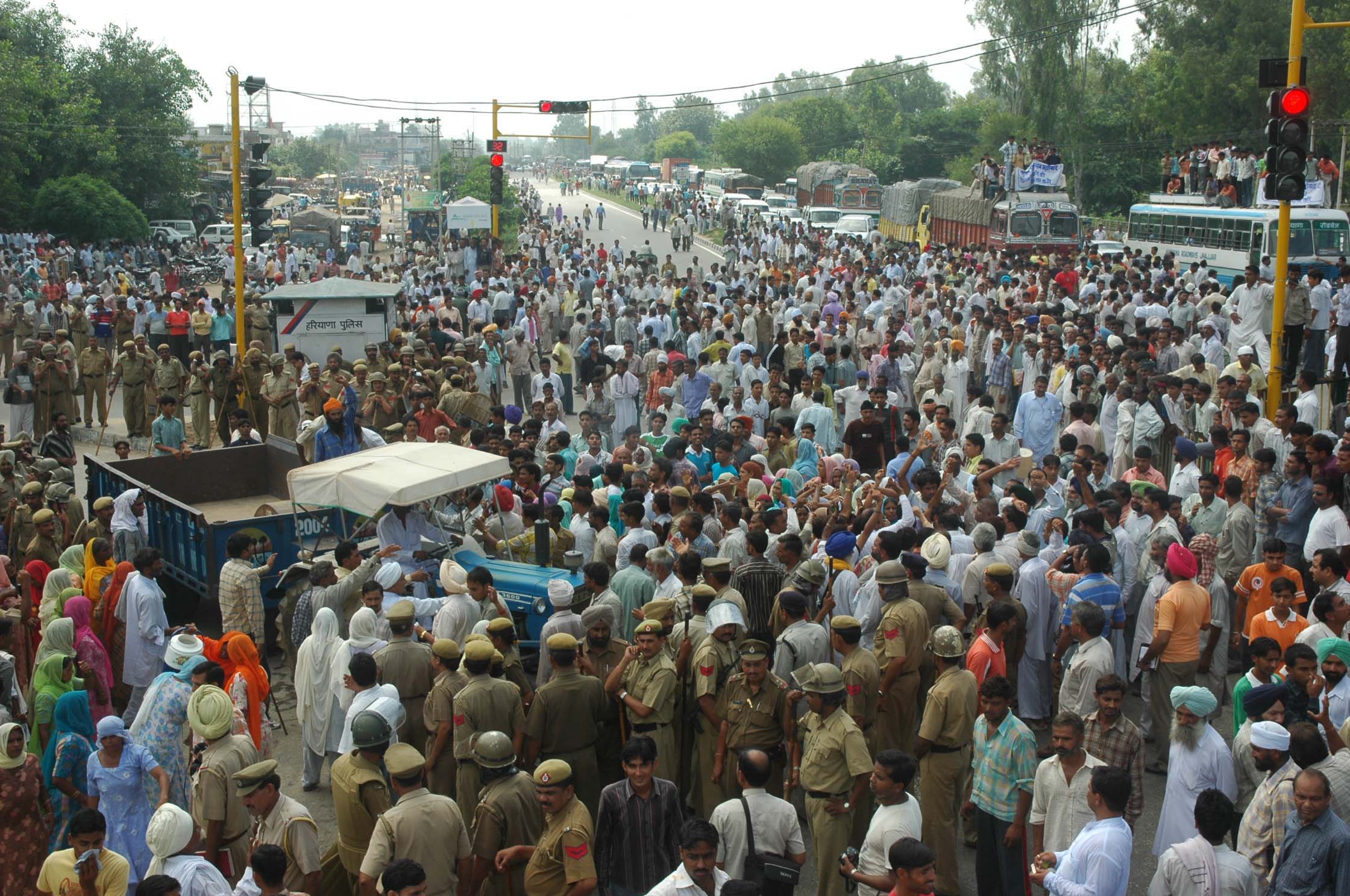 Villagers block the Delhi-Amritsar national highway in Shahabad (Kurukshetra) in protest against police inaction on Monday. 