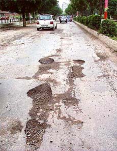 Potholes on the Pakhowal road in front of Nehru Sidhant Kendra in Ludhiana on Monday.