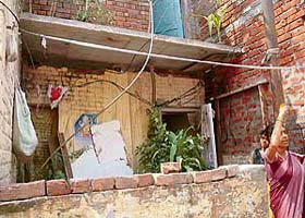Loose electricity wires dangle in the compound of a house at Ram Darbar, Phase II