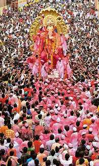 Devotees throng a major road as a huge idol of Lord Ganesha is paraded through streets of Mumbai on Wednesday at the end of the 10-day-long Ganesha festival.