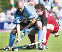Germanys Sebastian Biederlack (right) fights for the ball with Viren Rasquinha during their World Cup match at the Warsteiner Hockey Park Stadium in Monchengladbach on Wednesday.