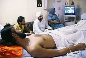 Sandeep Singh watches the India-England match from his bed in the PGI on Thursday