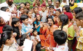 Magician O.P. Sharma regales children at the Chandigarh Press Club on Saturday.