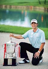 Australias Adam Scott poses for photographers after winning the Singapore Open golf tournament