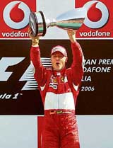 German Ferrari driver Michael Schumacher celebrates on the podium of the Monza racetrack on Sunday