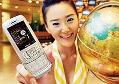This handout photo made available on Tuesday by Samsung Electronics shows a woman displaying a new mobile phone handset, SCH-V920, in Seoul.