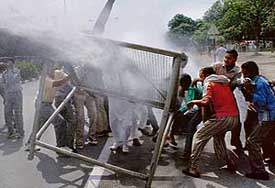 Water cannons being used to disperse members of the Unemployment PTI