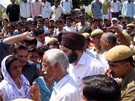 Hisar DC Phateh Singh Dagar and SSP Arshinder Singh Chawla try to placate protesters blocking road against the alleged sexual exploitation of girl students by Vishwas Senior Secondary School director in Hisar on Tuesday.