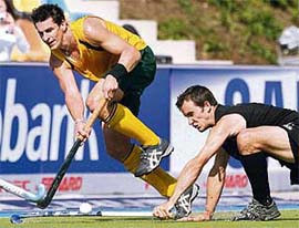 New Zealands Blair Hopping (right) fights for the ball with Australias Jamie Dwyer during their hockey World Cup match in Monchengladbach on Tuesday.