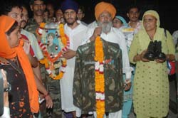 Indian Army personnel bring the uniform of Honorary Captain Harbhajan Singh, whose soul is believed to guard the border posts even 38 years after his death, at Jalandhar railway station on Thursday night. 