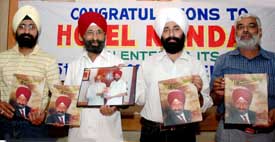 Mr N.S. Nanda, an hotelier, and others with his pictorial autobiography at a function in Ludhiana on Wednesday