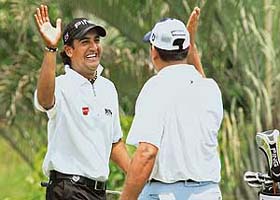 Shiv Kapur celebrates with Gaurav Ghei after scoring an eagle during the second round of the World Cup qualifiers at the Seri Selangor Golf Club in Kuala Lumpur