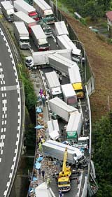 Crashed cars and trucks are seen on a highway in Nagano Prefecture, west of Tokyo,