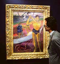 Christie's Head of Impressionist and Modern Art Olivier Camu poses with French artist Paul Gauguin's "L'homme a la hache", which is displayed at an auction house in central London on Friday. The piece forms part of Christie's New York Impressionist and Modern Art sale and is expected to sell between $40 and $60 million in November.