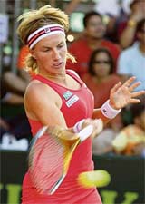 Russias Svetlana Kuznetsova returns the ball to Lindsay Davenport of the USA during the semifinal of the Bali international tennis tournament on Saturday. Kuznetsova won 7-6, 7-6. In the final, she will face Frances Marion Bartoli, who beat Switzerlands Patty Schnyder 6-4, 6-4 in the other semifinal.