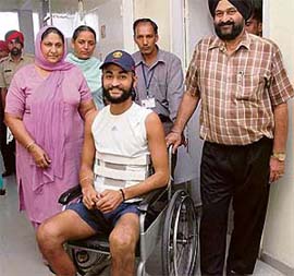 Ace drag-flicker Sandeep Singh, accompanied by his parents, is all smiles on being discharged from the PGI in Chandigarh on Saturday.