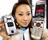 A campaign girl for Japanese telecom giant NTT DoCoMo displays a new mobile handset, "FOMA N902iX high-speed", produced by Japan's electronics giant NEC, at its launch in Tokyo on Sunday