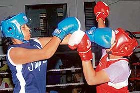 Bimla Rani of Dev Samaj College for Women, Sector 45, lands a punch on the face of Anu of Sarda Sarvhitkari School, Sector 40, in the 70-kg final of the first Chandigarh sub-junior womens boxing championship at the Sports Complex, Sector 42, Chandigarh