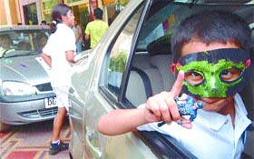 A child strikes a pose during a car rally Fun with the Family in the Capital