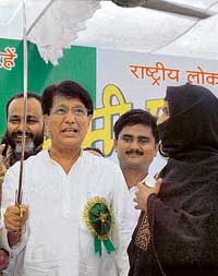 President of the Rashtriya Lok Dal Ajit Singh holds a sword presented to him by a Muslim woman during 'Kaumi Ekta Sammelan' in Allahabad on Sunday.
