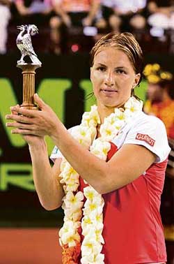 Russias Svetlana Kuznetsova holds the trophy after beating Frances Marion Bartoli in the final of the Bali international tennis tournament in Nusa Dua, Indonesia, on Sunday
