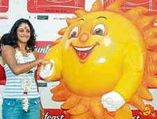 US-based tennis player Sunitha Rao shakes hands with the mascot of the Sunfeast Open during a road show in Kolkata on Sunday