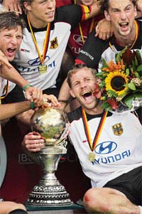 German players celebrate with the trophy after beating Australia 4-3 in the final of the hockey World Cup in Monchengladbach 