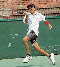 Ajay Yadav returns a shot against Ashwani during the AITA series at the CLTA, Chandigarh, on Tuesday. 